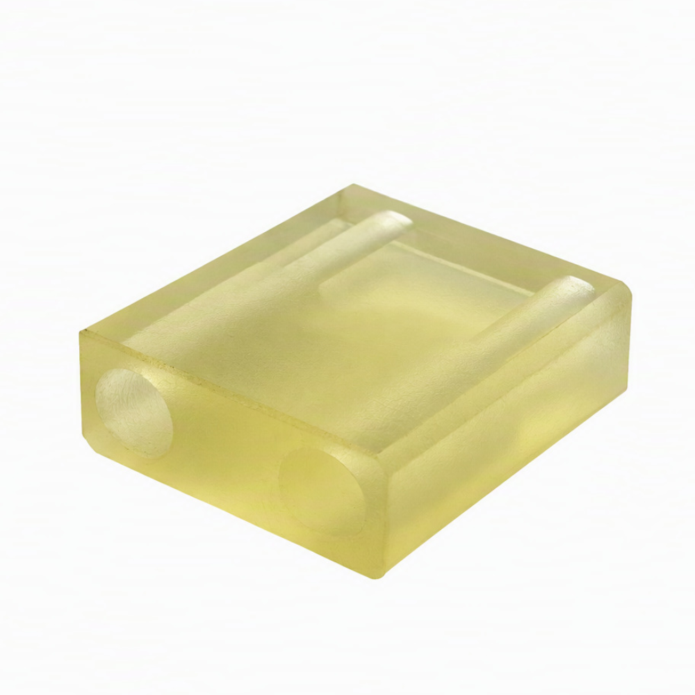 Custom machined plastic block with parallel grooves and side holes